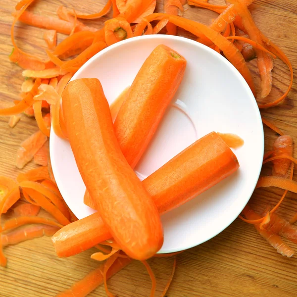 Ripe carrots in white plate — Stock Photo, Image