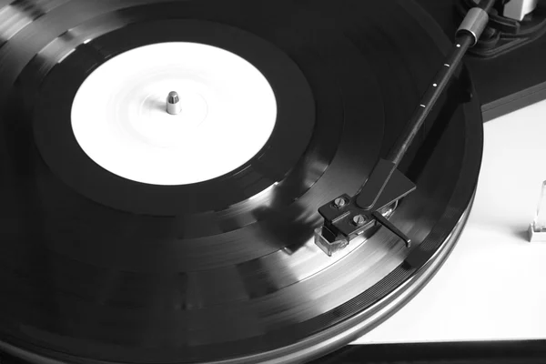 Turntable with playing vinyl record close seup — стоковое фото