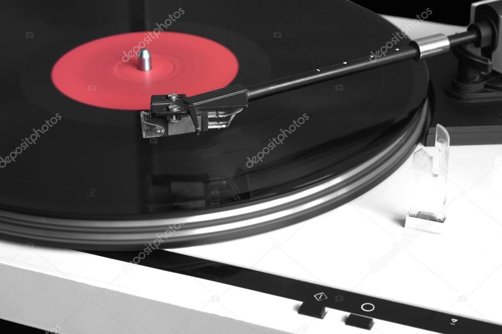 Modern record player with vinyl record closeup