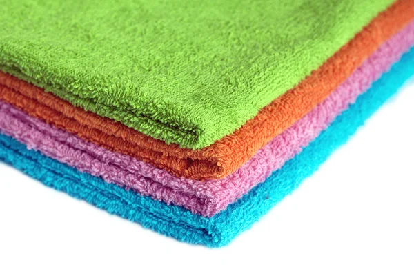 Four bath towels of different colors stacked isolated — Stock Photo, Image