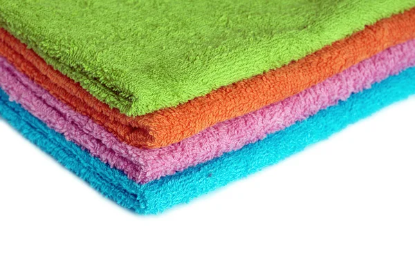 Four bath towels of different colors stacked isolated — Stock Photo, Image