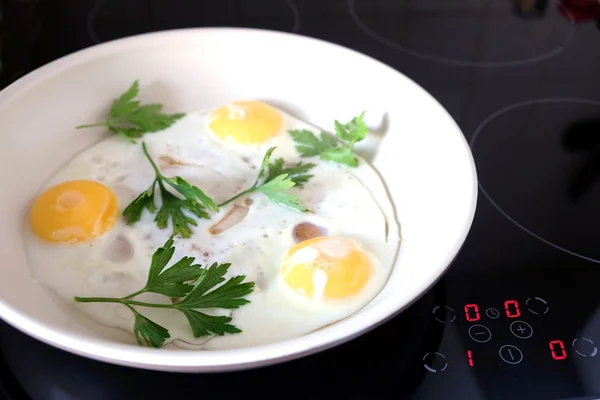 Three appetizing fried eggs in the pan — Stock Photo, Image