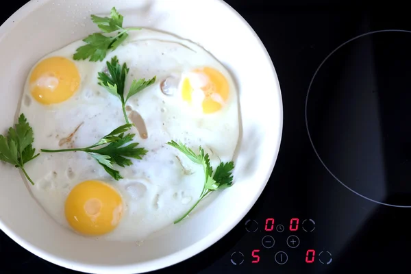 Three appetizing fried eggs in pan — Stock Photo, Image