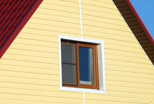Wall covered with yellow siding — Stock Photo, Image