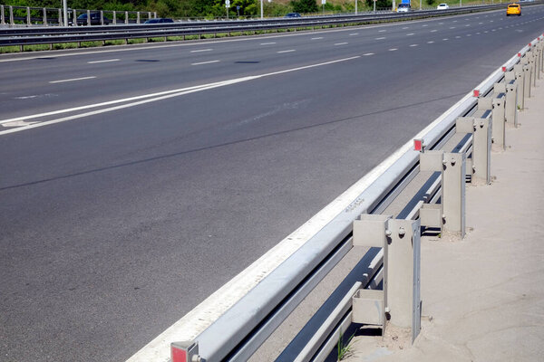 Cityscape with urban highway and pedestrian way with fence in sunny summer day horizontal photo side view