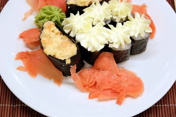 Zátiší Chutnými Sushi Kousky Bílém Talíři Hnědé Proutěné Slámě Vrchní — Stock fotografie