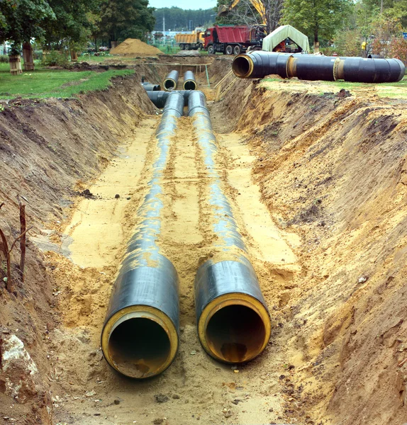 Neue Wasserleitungen, die an einem bewölkten Tag im Boden verlegt werden — Stockfoto