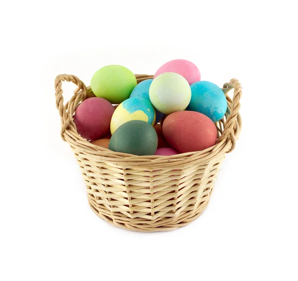Color Easter eggs in brown basket front view isolated — Stock Photo, Image