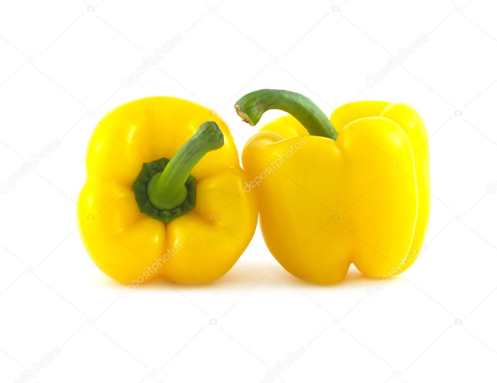 Two ripe yellow ripe bell peppers isolated on white