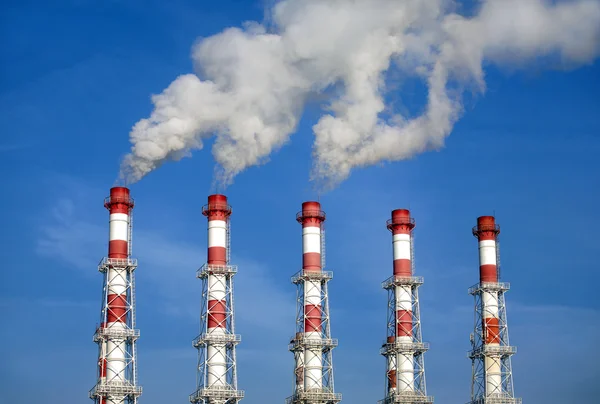 Industrial pipes with white smoke over blue sky. Horizontal photo — Stock Photo, Image