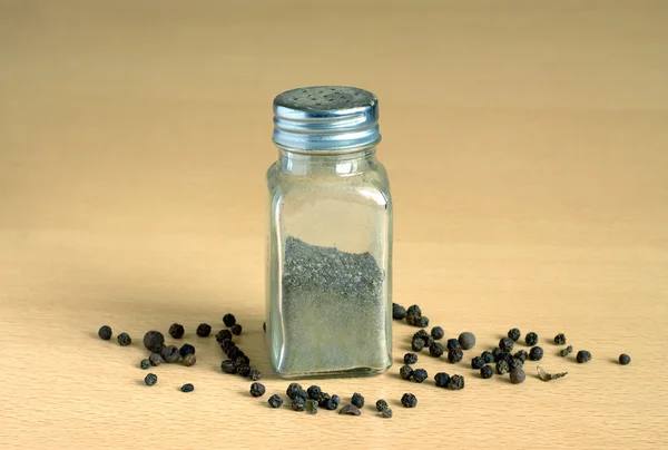 Pepper and spice jar on wooden surface closeup — Stock Photo, Image