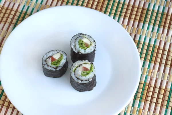 Sushi rolls on white plate closeup — Stock Photo, Image