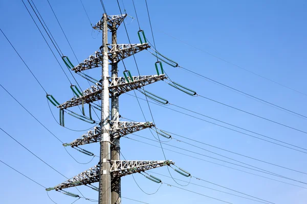 Högspännings-power line metall prop över klart molnfri blå himmel — Stockfoto