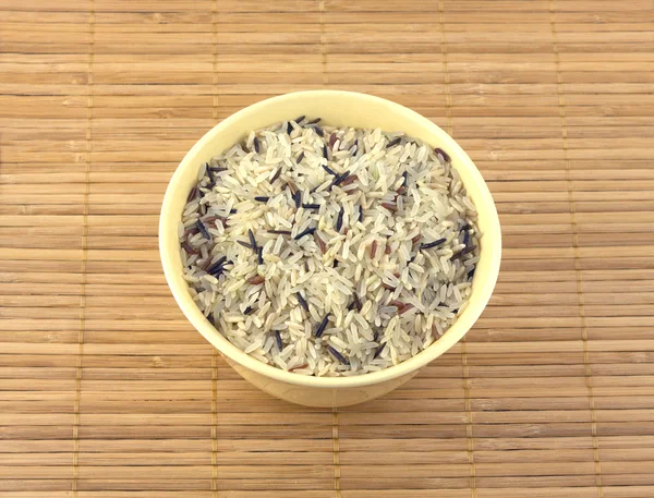 Color rice in bowl on  wicker mat — Stock Photo, Image