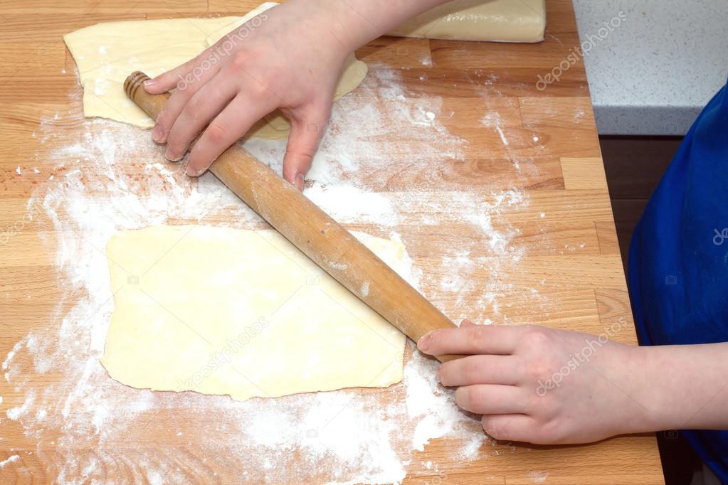Female hands preparing dough for baking