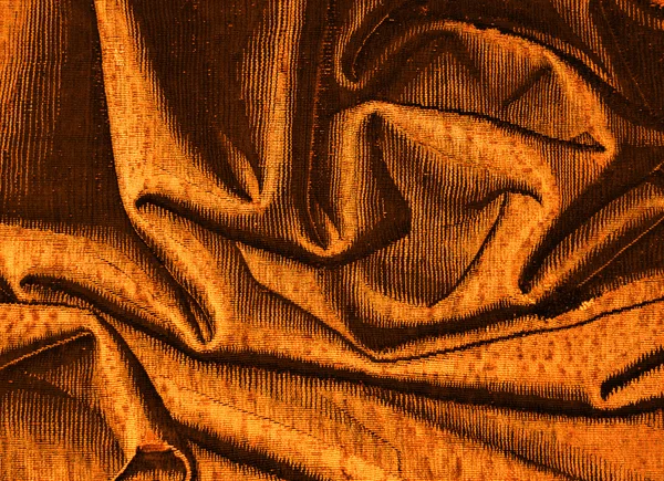 Golden brocade, fancywork, folds of the fabric — Stock Photo, Image