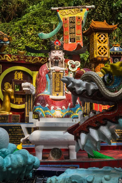 Estatua de mosaico del dios de la riqueza en el templo de Tin Hau, bahía de Repulse, Hong Kong, China Imágenes de stock libres de derechos