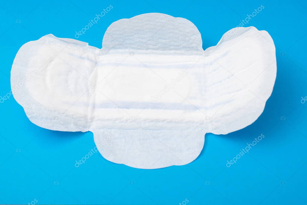 Feminine pad on a blue background. Hygiene product for menstruation.