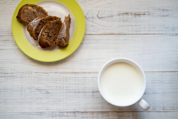 stock image Milk in a cup. Morning breakfast with a muffin.