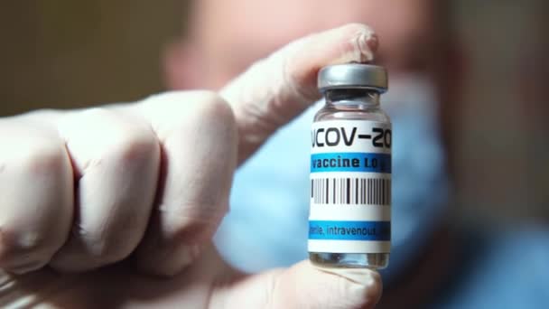 Coronavirus Vaccine Man Medical Mask Holds Bottle Vaccine — Stock Video