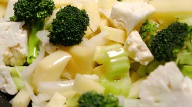 Farklı sebzeler. Kamera çiğ sebze karışımına bakar. Vejetaryen güveci pişiriyorum..