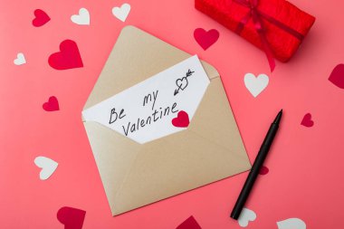 Sevgilim ol - kırmızı arkaplanda kalplerle yazılmış bir aşk mektubu.