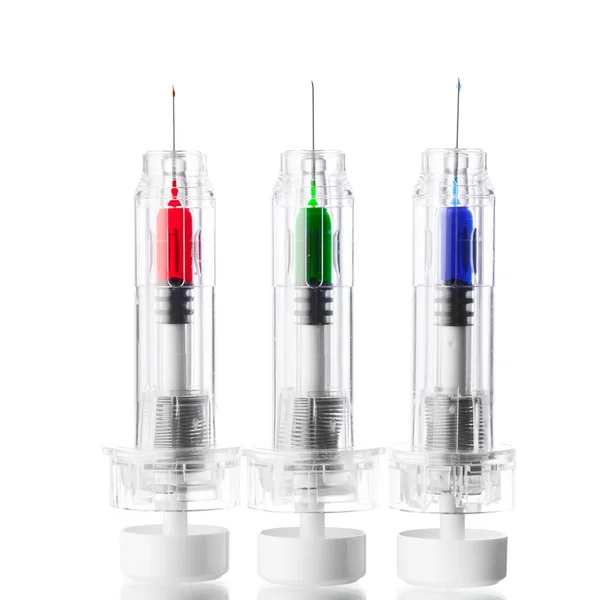 Disposable syringes with multicolored vaccines, isolated on white — Stock Photo, Image