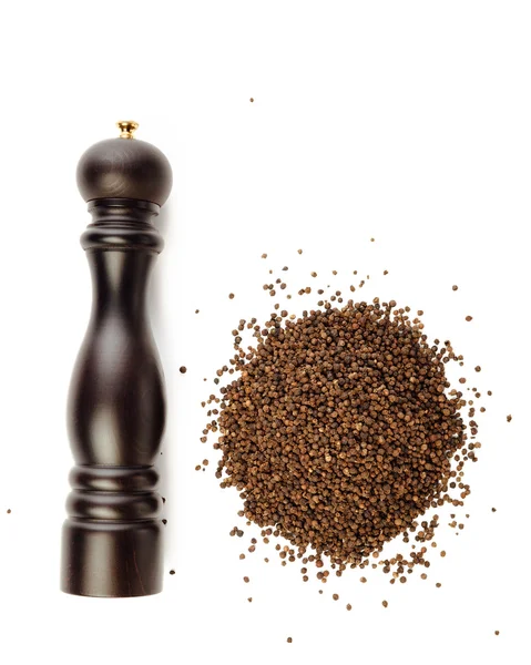 Pepper mill and peppercorns heap, isolated on white — Stock Photo, Image