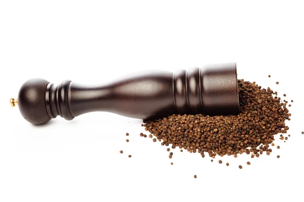 Pepper mill on peppercorns heap, isolated on white — Stock Photo, Image