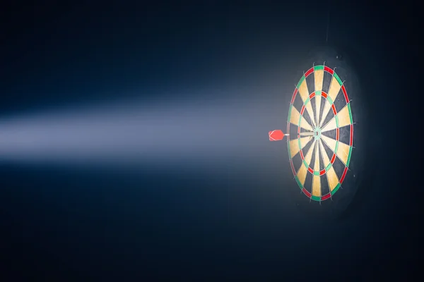 Placa de dardos iluminado com um holofote — Fotografia de Stock