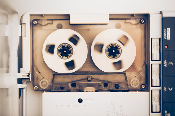 rewinding of vintage audio tape compact cassette, sepia tone