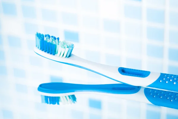 Toothbrush on blue tile background — Stock Photo, Image