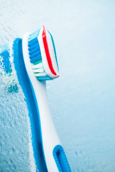 Toothbrush with red stripe toothpaste — Stock Photo, Image