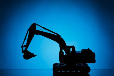 mavi arkaplanda kazıcı model silueti