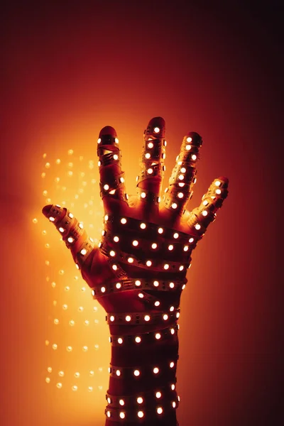 Mão Humana Coberta Com Luzes Led Laranja Fundo Iluminado — Fotografia de Stock