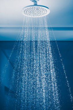 douche with water stream, blue background
