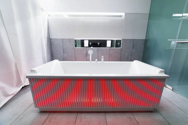 bathtub with abstract red illumination in a bathroom