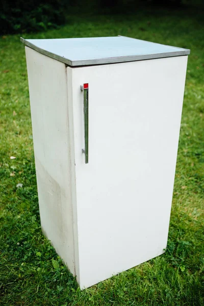 vintage fridge on green grass