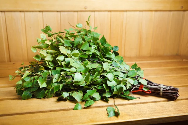 Bunch of green birch twigs in sauna — Stock Photo, Image