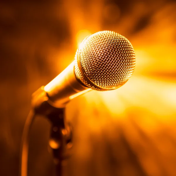 Golden microphone on stage — Stock Photo, Image