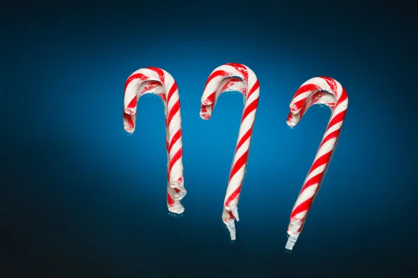 Candy canes on blue background — Stock Photo, Image