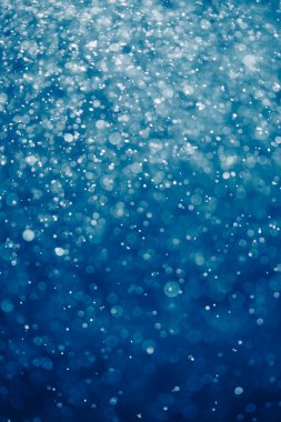 mavi arka plan ile bokeh parçacıklar