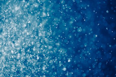 abstract blue background with bokeh particles