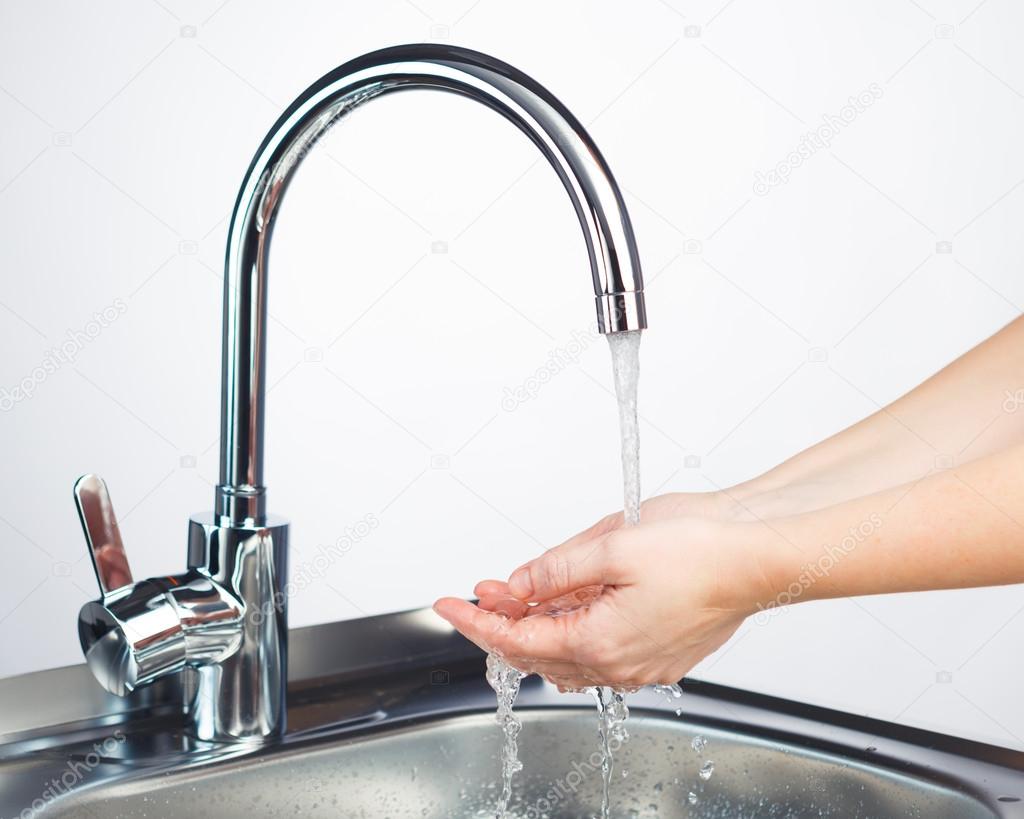 mixer tap with water and washing hands