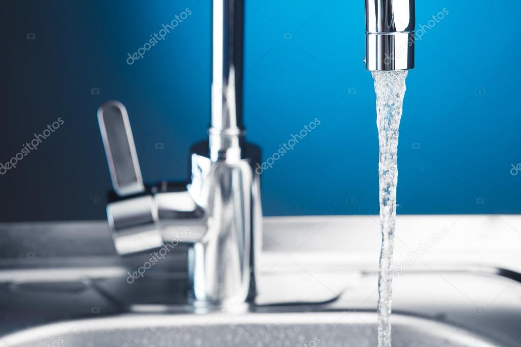 mixer tap with flowing water, closeup view