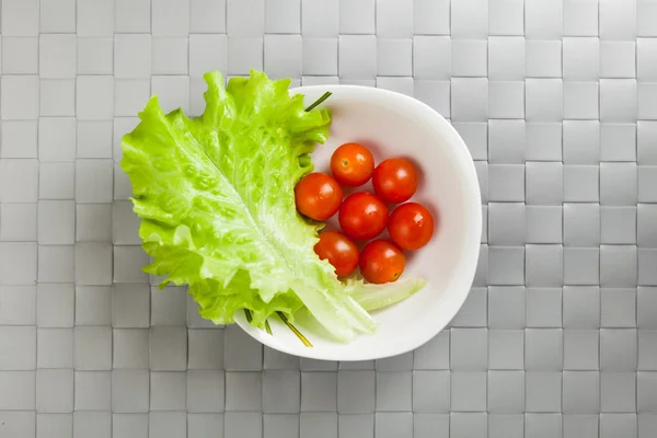 Verduras frescas en el plato, fondo de alfombra de lugar gris —  Fotos de Stock