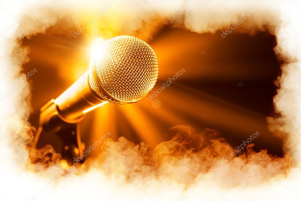 golden microphone on stage with smoke frame