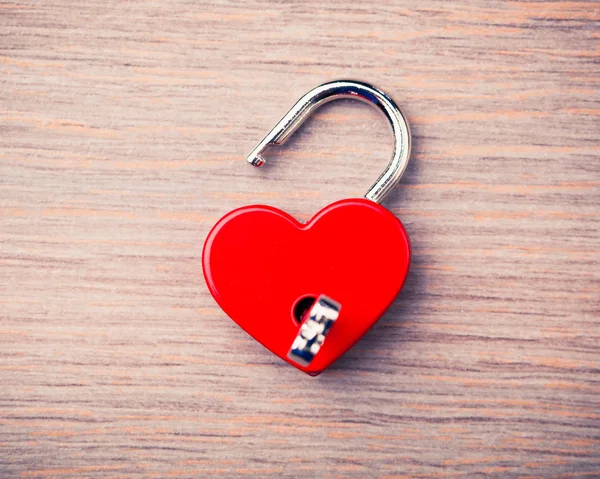 Heart shaped opened lock on wooden background — Stock Photo, Image