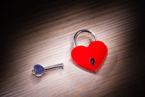Heart shaped closed lock on wooden background — Stock Photo, Image
