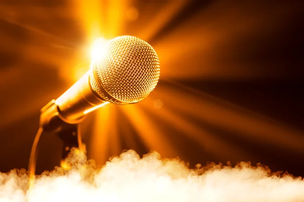 Golden microphone on stage with smoke — Stock Photo, Image